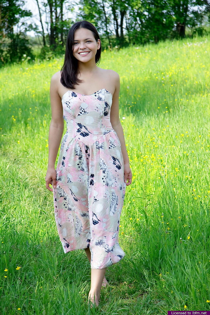 Nice Asian teen frees her breasts and pussy from her dress in a grassy meadow