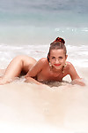 Petite girl Francoise removes her bikini before a hardcore DP on the beach