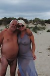 Mature blonde Dimonty eats an ice cream treat after nude modeling at the beach