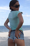 Sweet teen girl Alexiss Capri showing off nice ass in thong underwear on beach