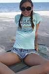 Sweet teen girl Alexiss Capri showing off nice ass in thong underwear on beach