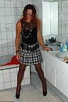 Mature redhead Kyras Nylons hikes her skirt over her pantyhose in the bathroom