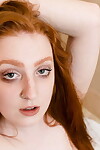 Pale redhead uncovers big naturals before stretching out her pussy in shower