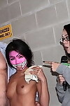 Brunette chick dons a face mask before sucking a cock for money
