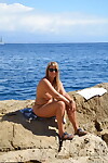 Amateur BBW with sagging boobs poses nude on rocks to delight of passing ships